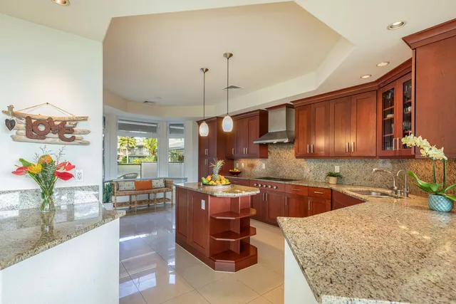 a kitchen with a stove a sink and a wooden cabinets