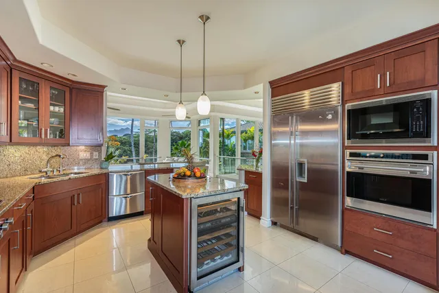 a kitchen with a sink stainless steel appliances and counter space