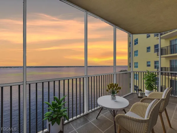 a view of a balcony with chair and glass door
