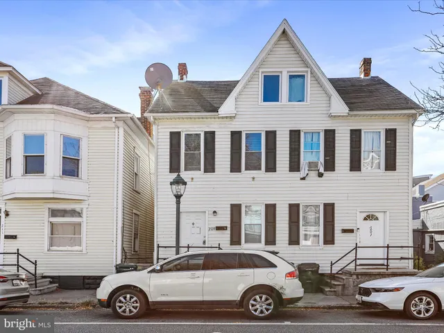 a front view of a house with parking space