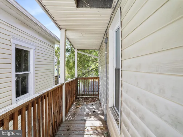 a view of a balcony with wooden floor