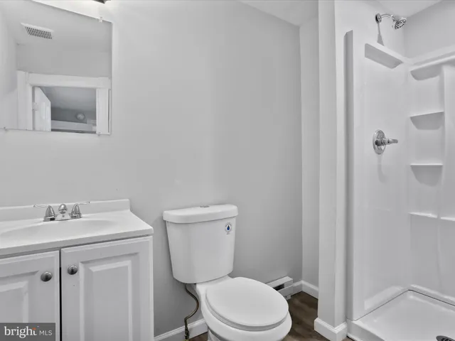 a white toilet sitting next to a bathroom sink