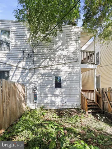 a brick building with a bench in front of main door