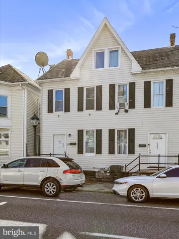 a view of a car parked in front of a house