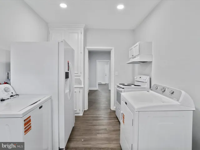 a kitchen with a sink a stove and cabinets