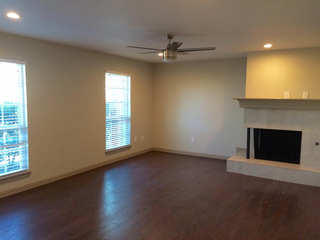 1416 Elms Road Irving, TX 75060 - Photo 2 of 7 an empty room with windows and fireplace