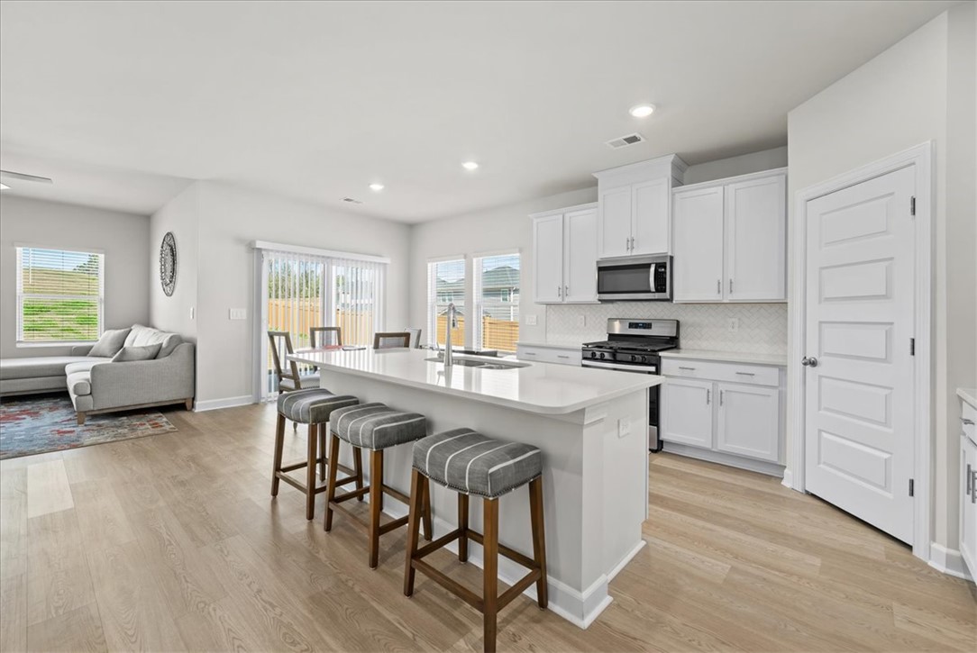 106 Purcell Way Easley, SC 29642 - Photo 5 of 39 This bright kitchen features an open concept layout, a kitchen island, and contemporary appliances.