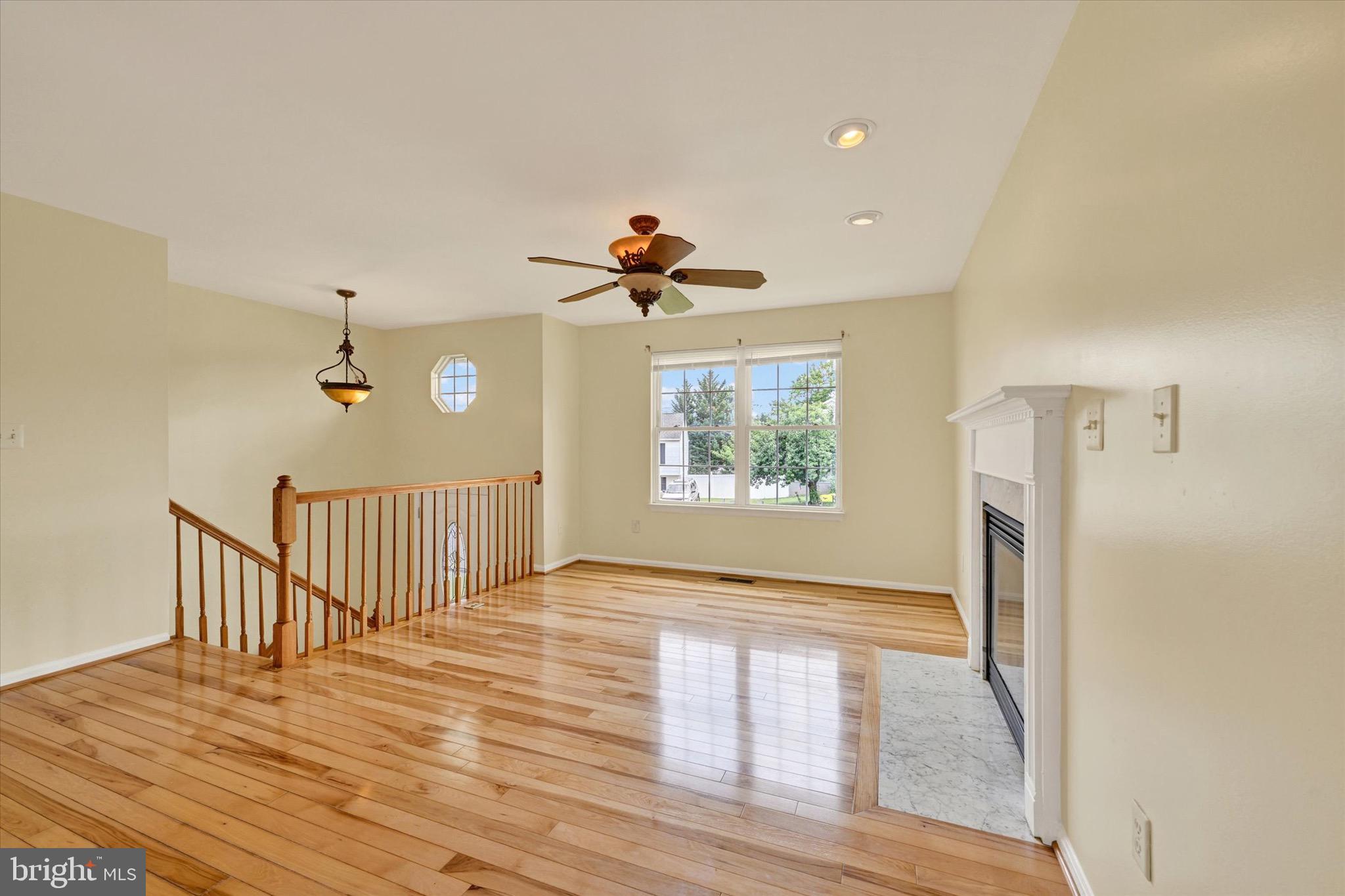 21 Box Circle Baltimore, MD 21221 - Photo 3 of 23 a view of a hallway with wooden floor and a ceiling fan