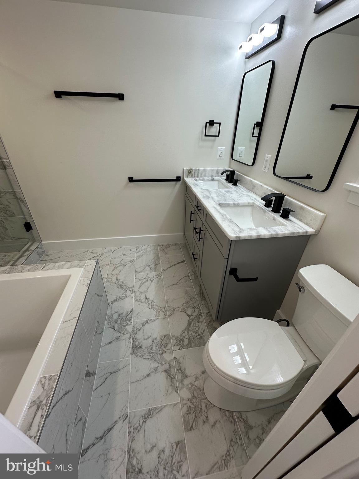 3210 8th Street Southeast, Unit 1 Washington, DC 20032 - Photo 13 of 14 a white toilet sitting next to a bathroom sink