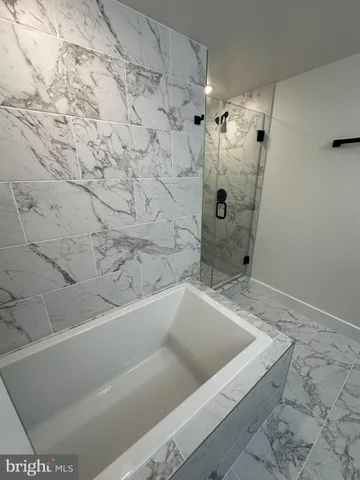 a bathroom with a bathtub and shower