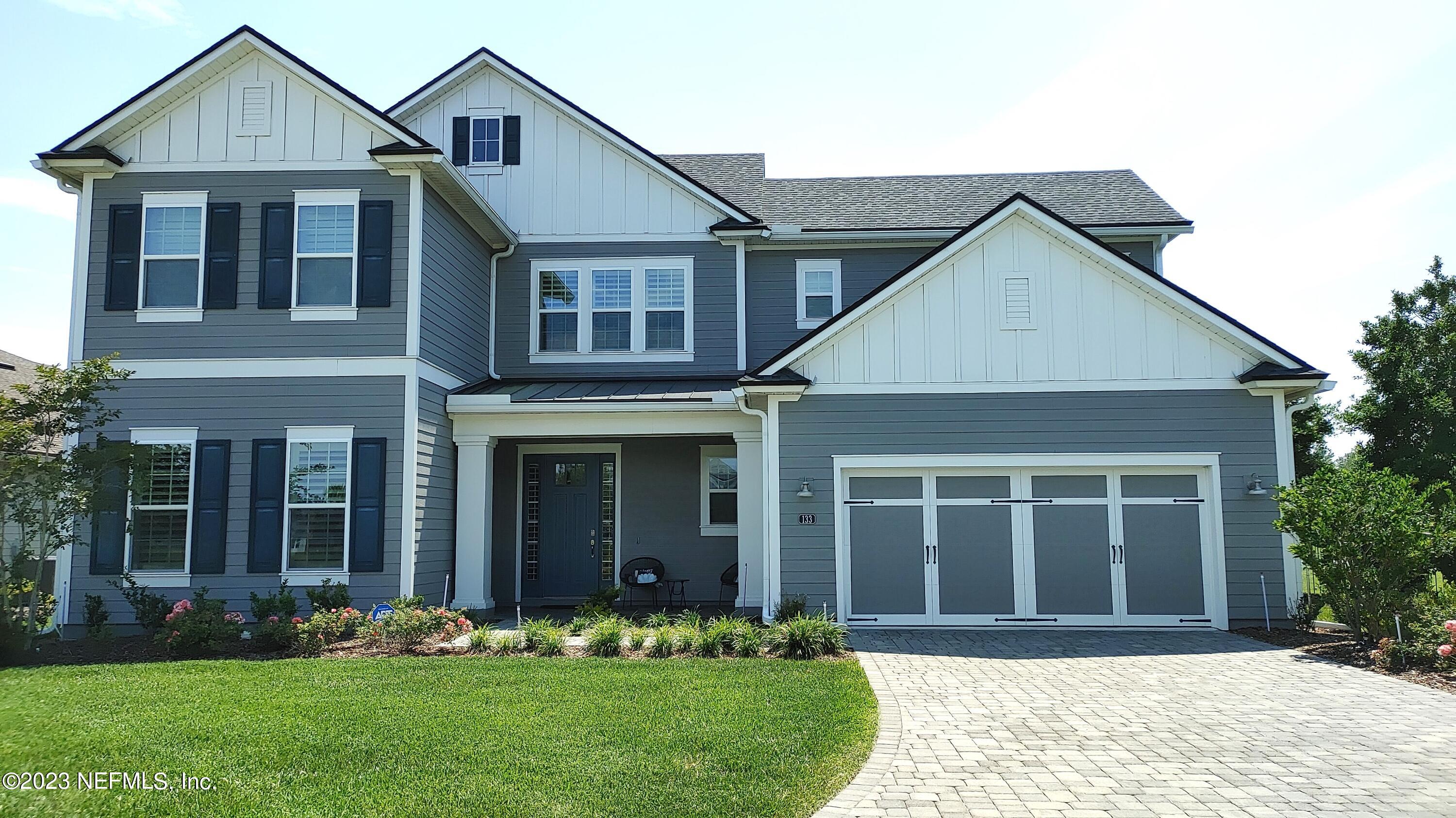 a front view of a house with a yard and porch