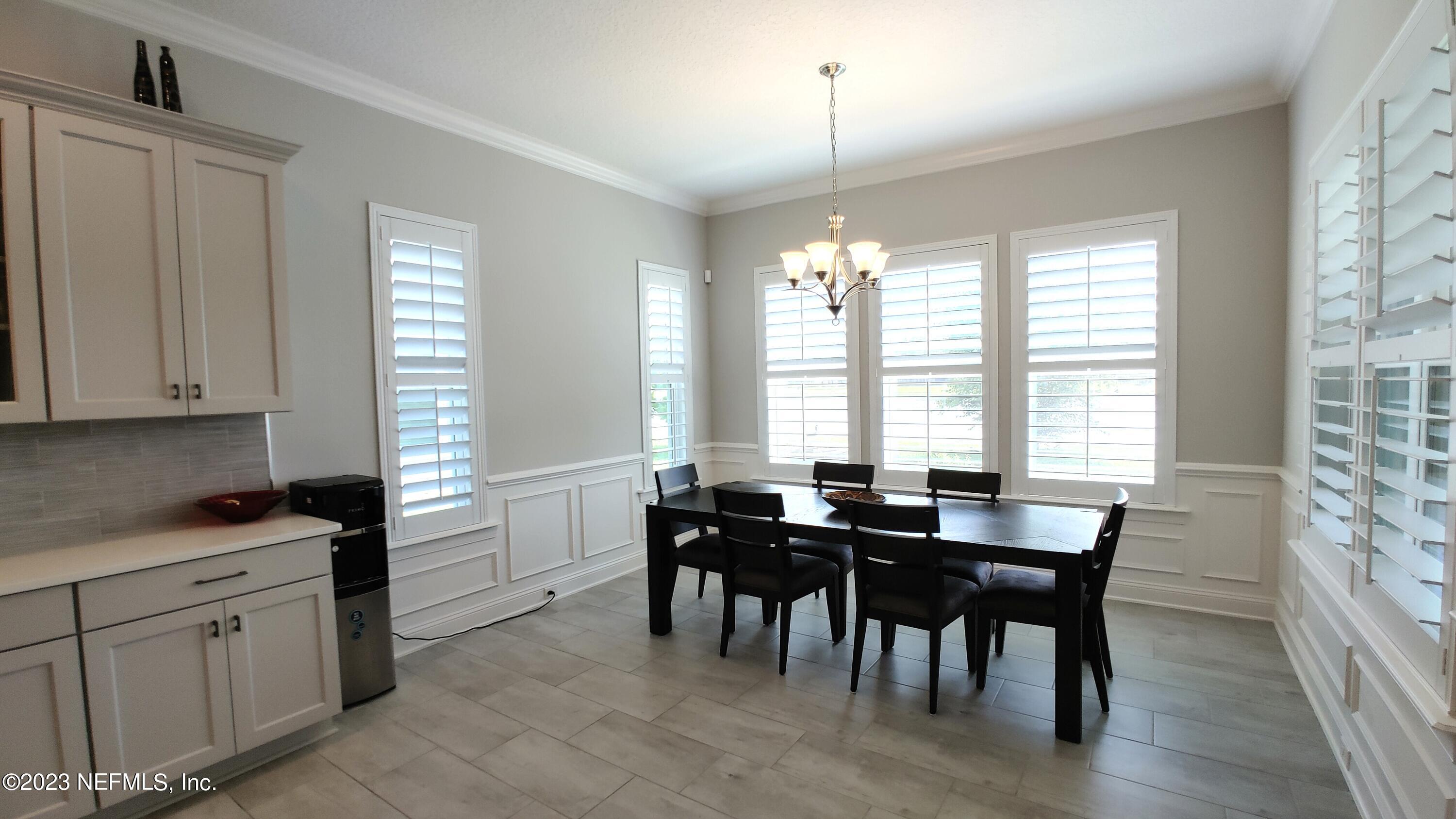 133 Pavati Point St. Johns, FL 32259 - Photo 12 of 46 a view of a dining room with furniture and chandelier