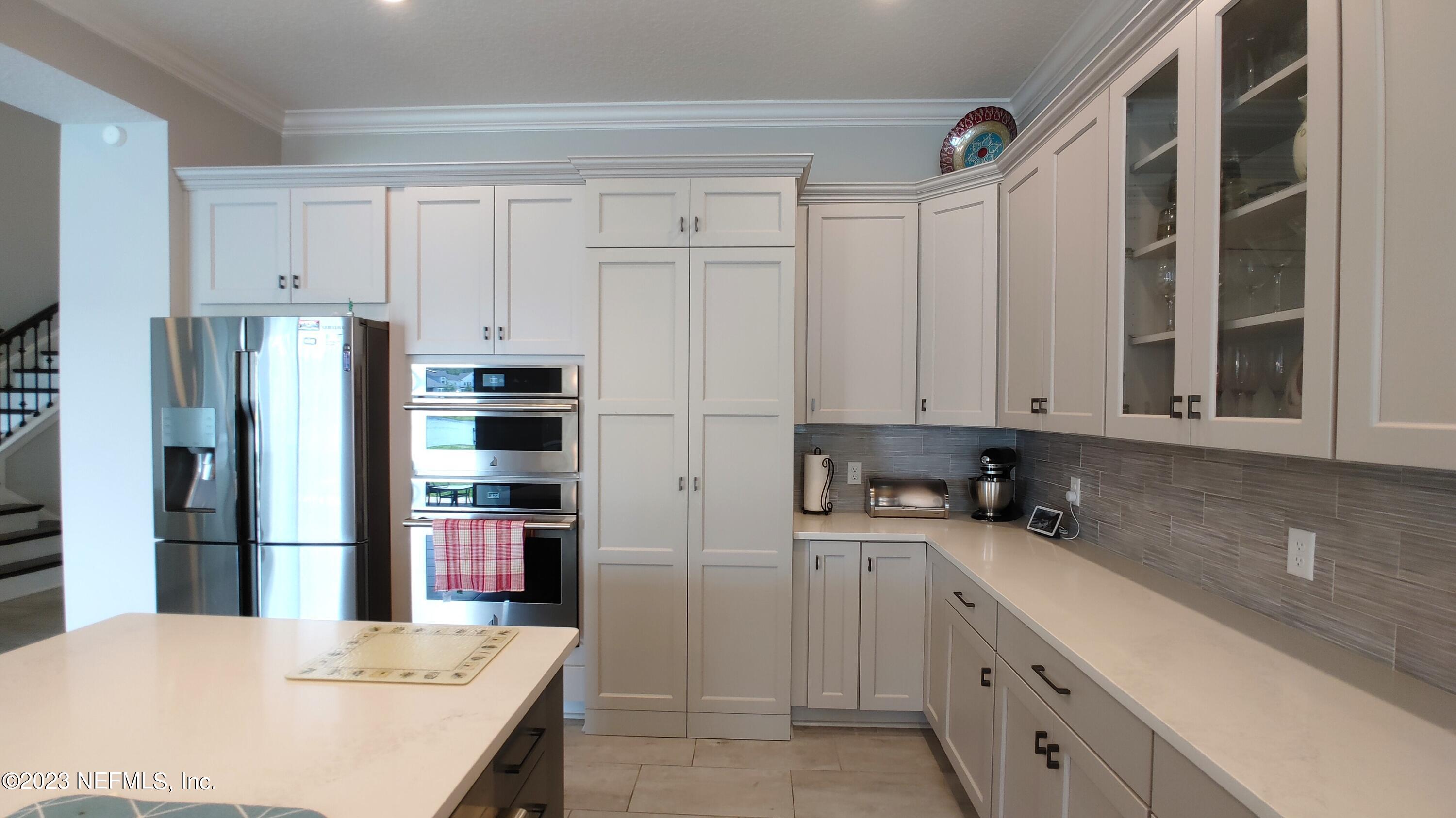 133 Pavati Point St. Johns, FL 32259 - Photo 13 of 46 a kitchen with a sink and refrigerator