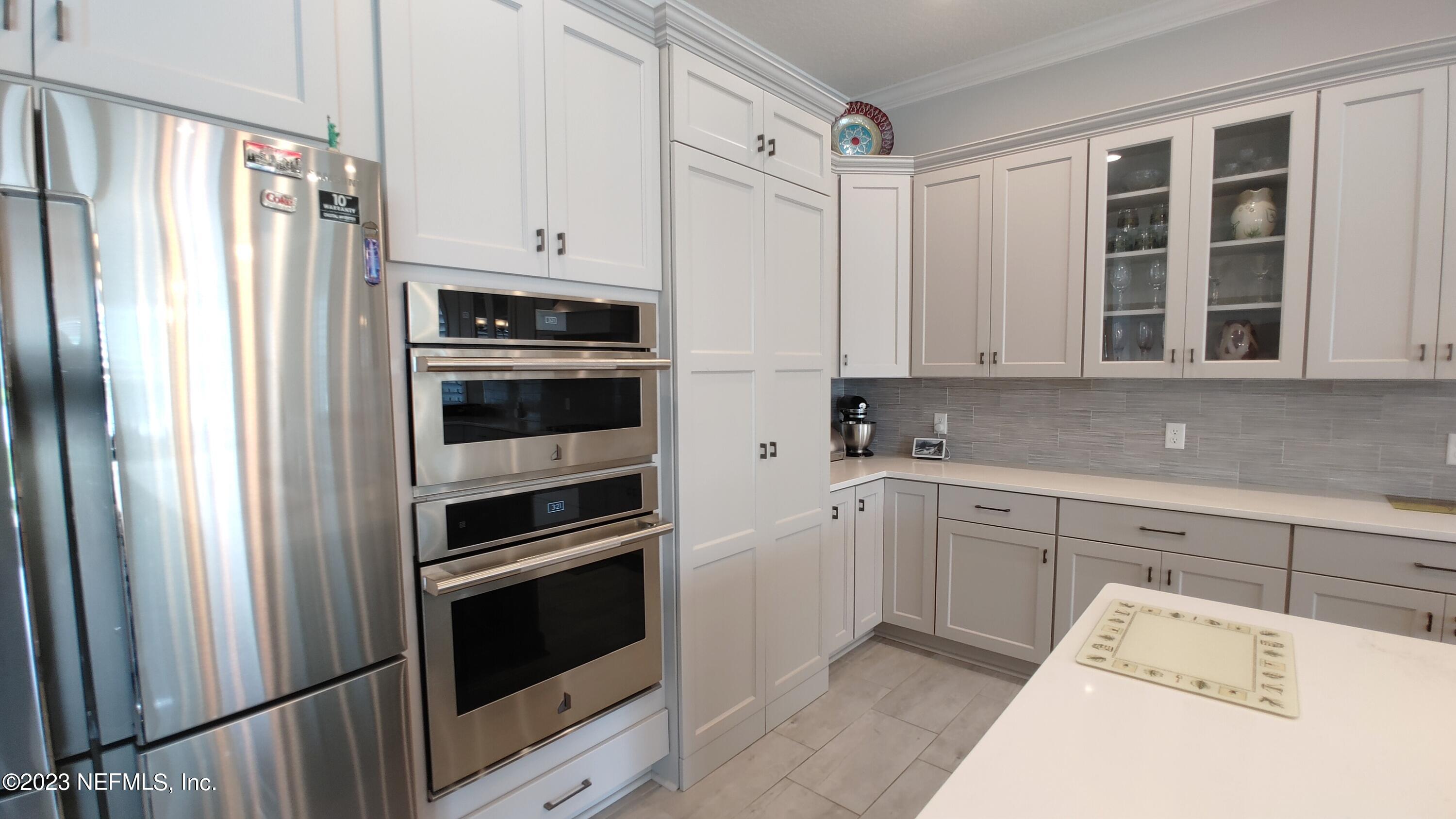 133 Pavati Point St. Johns, FL 32259 - Photo 15 of 46 a kitchen with granite countertop white cabinets and stainless steel appliances