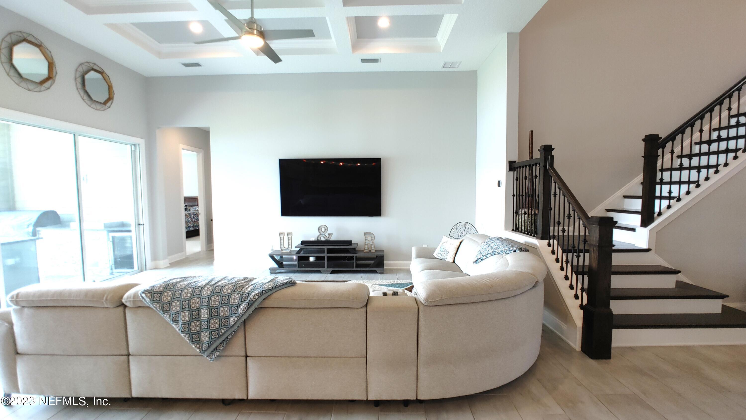 133 Pavati Point St. Johns, FL 32259 - Photo 18 of 46 a living room with furniture and a flat screen tv