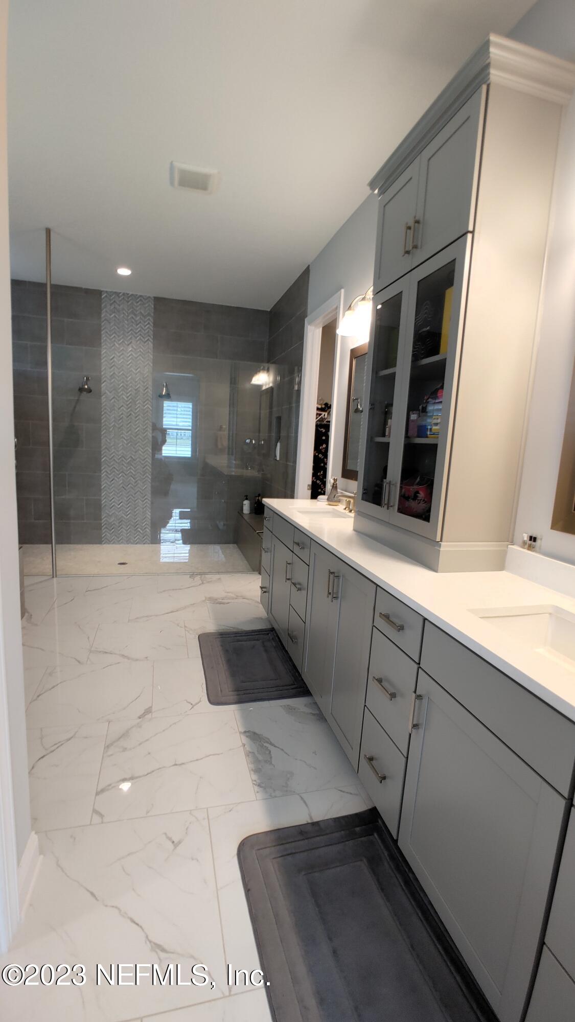 133 Pavati Point St. Johns, FL 32259 - Photo 21 of 46 a large bathroom with a large mirror vanity and shower