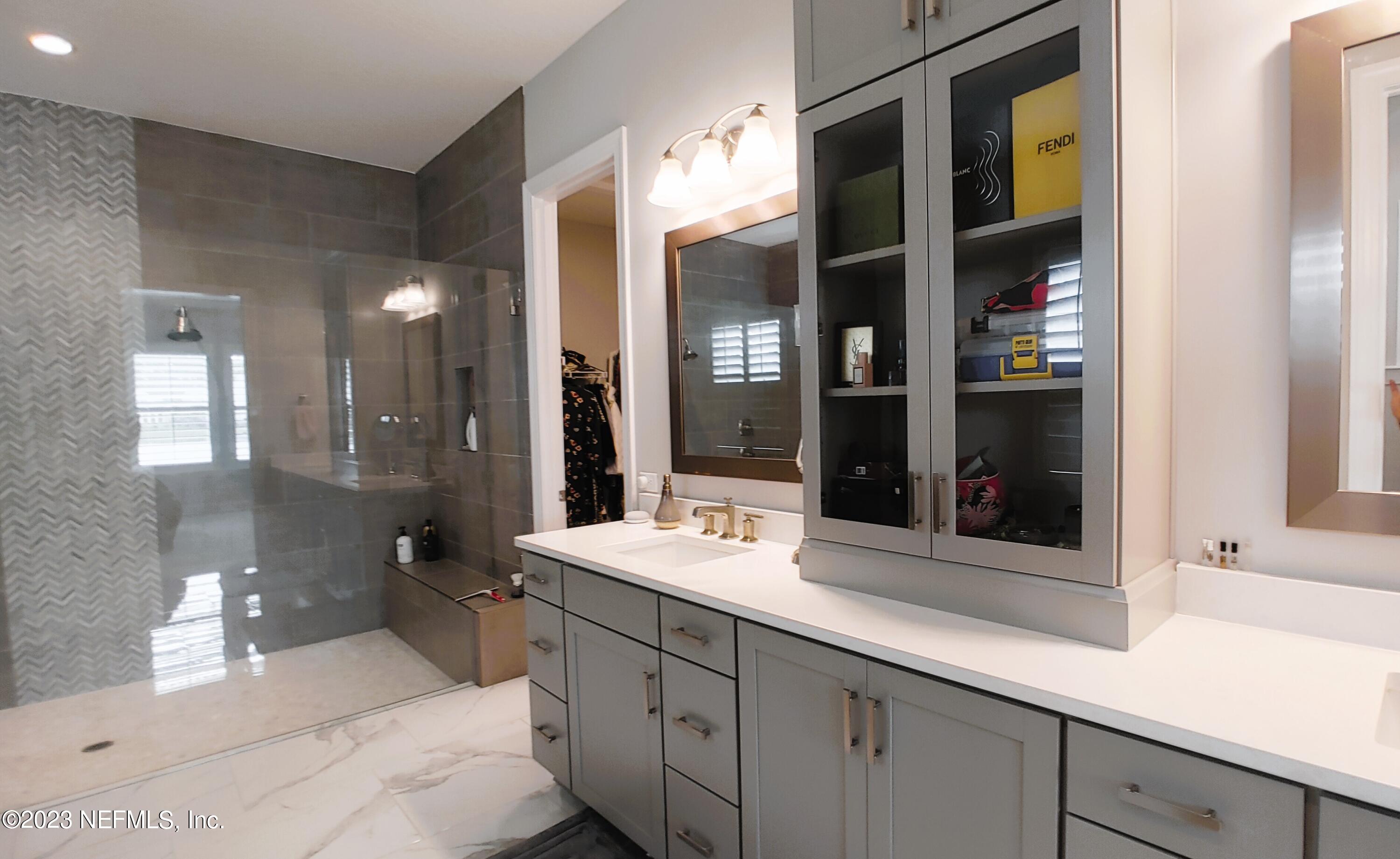 133 Pavati Point St. Johns, FL 32259 - Photo 23 of 46 a bathroom with a sink double vanity granite tub shower and a mirror