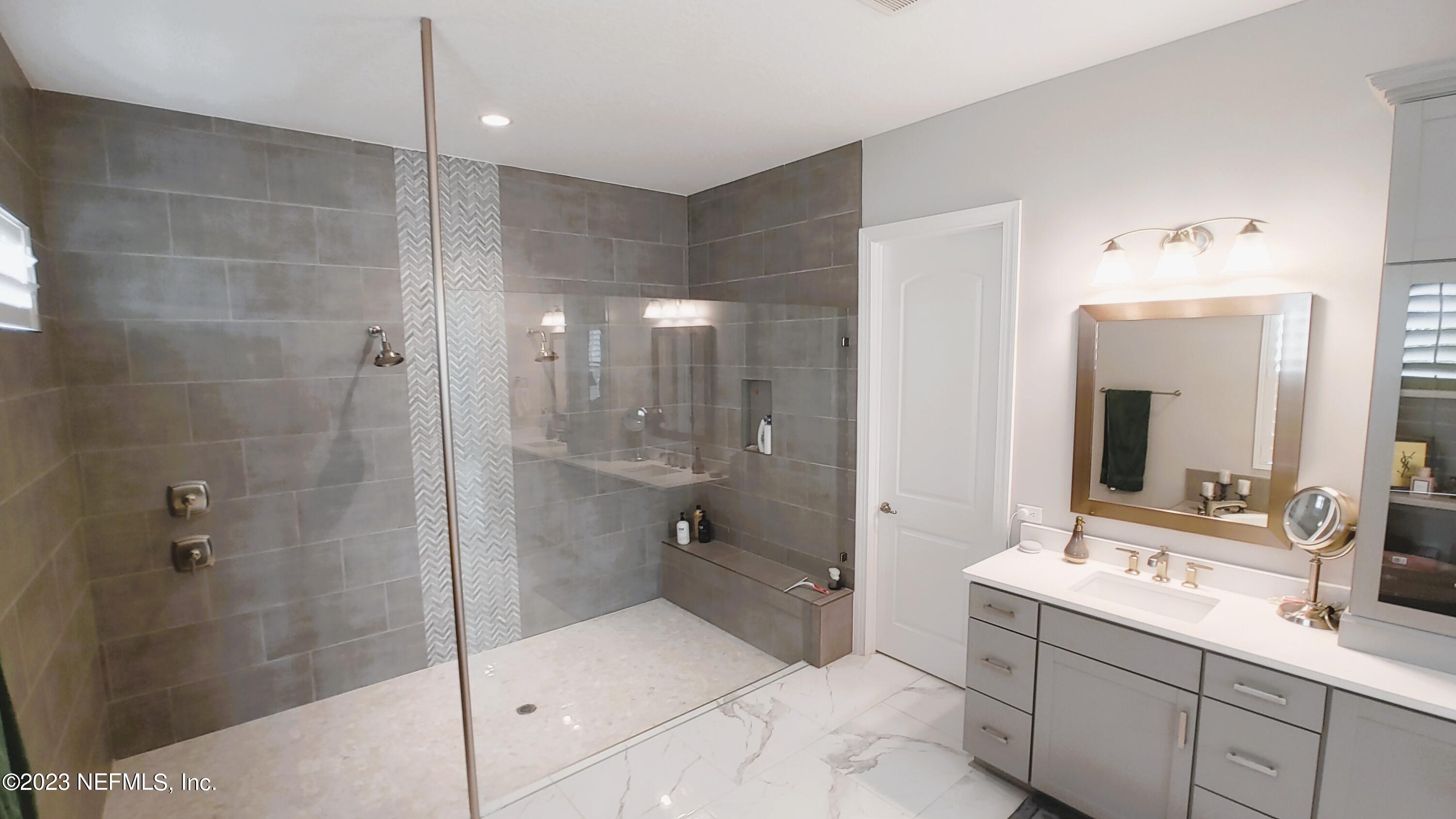 133 Pavati Point St. Johns, FL 32259 - Photo 25 of 46 a bathroom with a double vanity sink mirror and shower