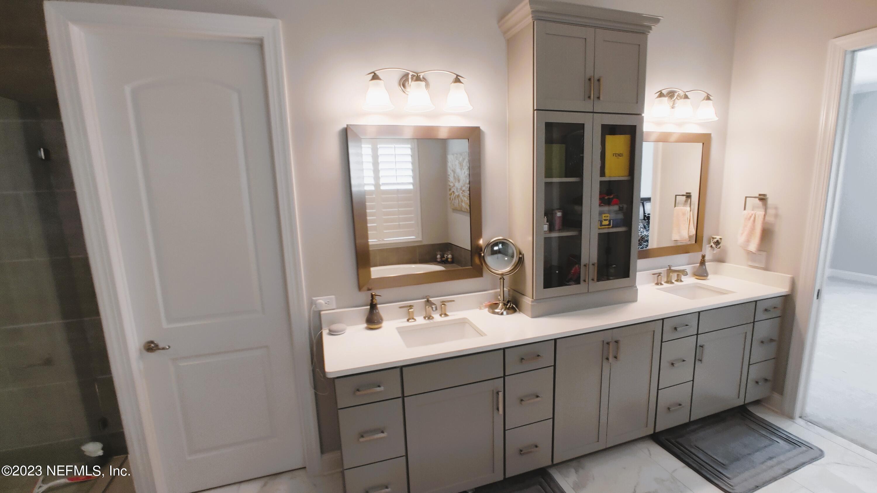 133 Pavati Point St. Johns, FL 32259 - Photo 26 of 46 a bathroom with a double vanity sink and mirror with shower