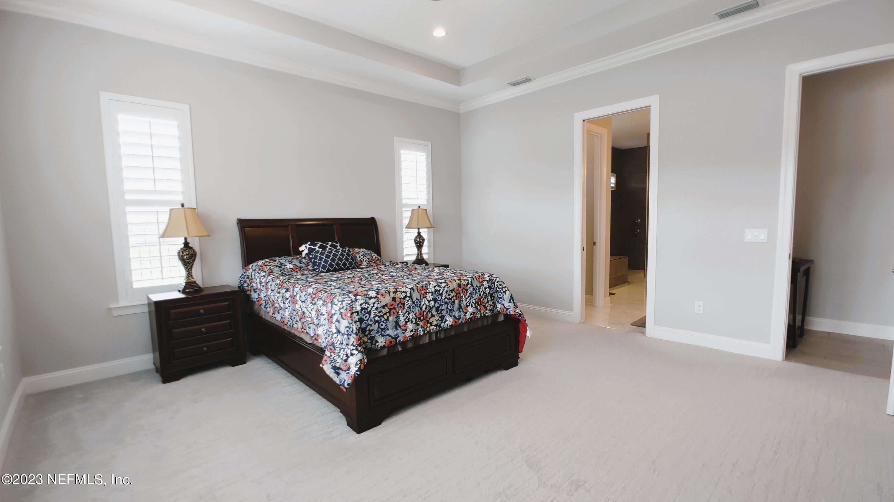 133 Pavati Point St. Johns, FL 32259 - Photo 27 of 46 a bedroom with a bed lamp and a window