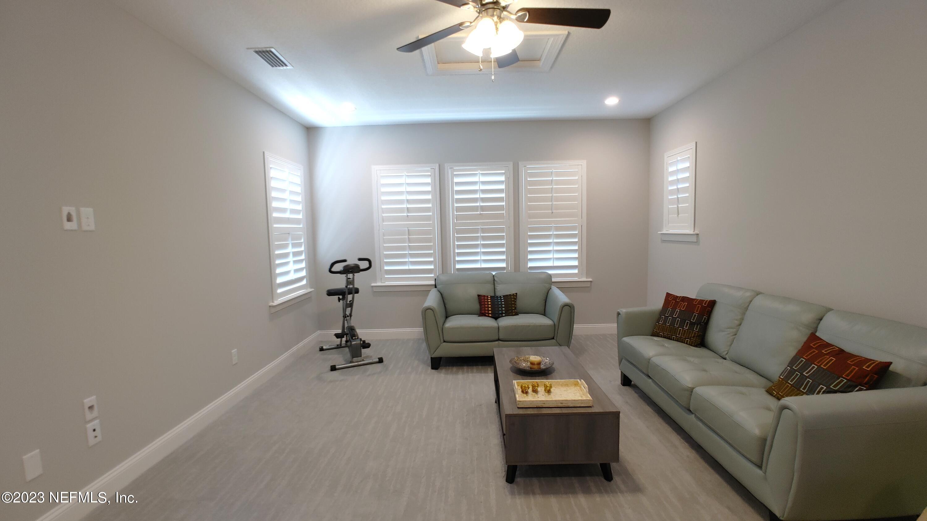 133 Pavati Point St. Johns, FL 32259 - Photo 35 of 46 a living room with furniture and a chandelier