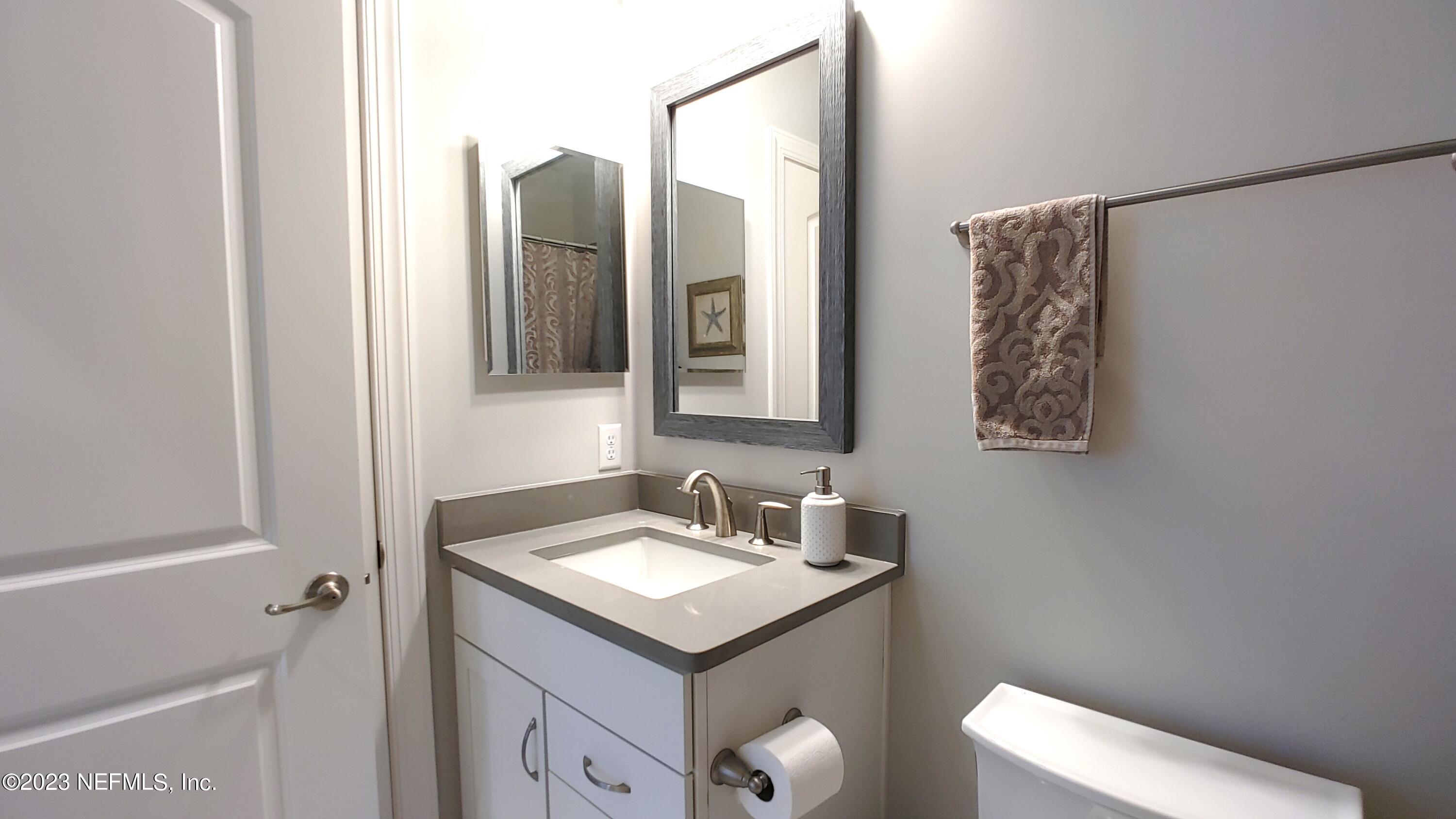 133 Pavati Point St. Johns, FL 32259 - Photo 38 of 46 a bathroom with a toilet sink and mirror