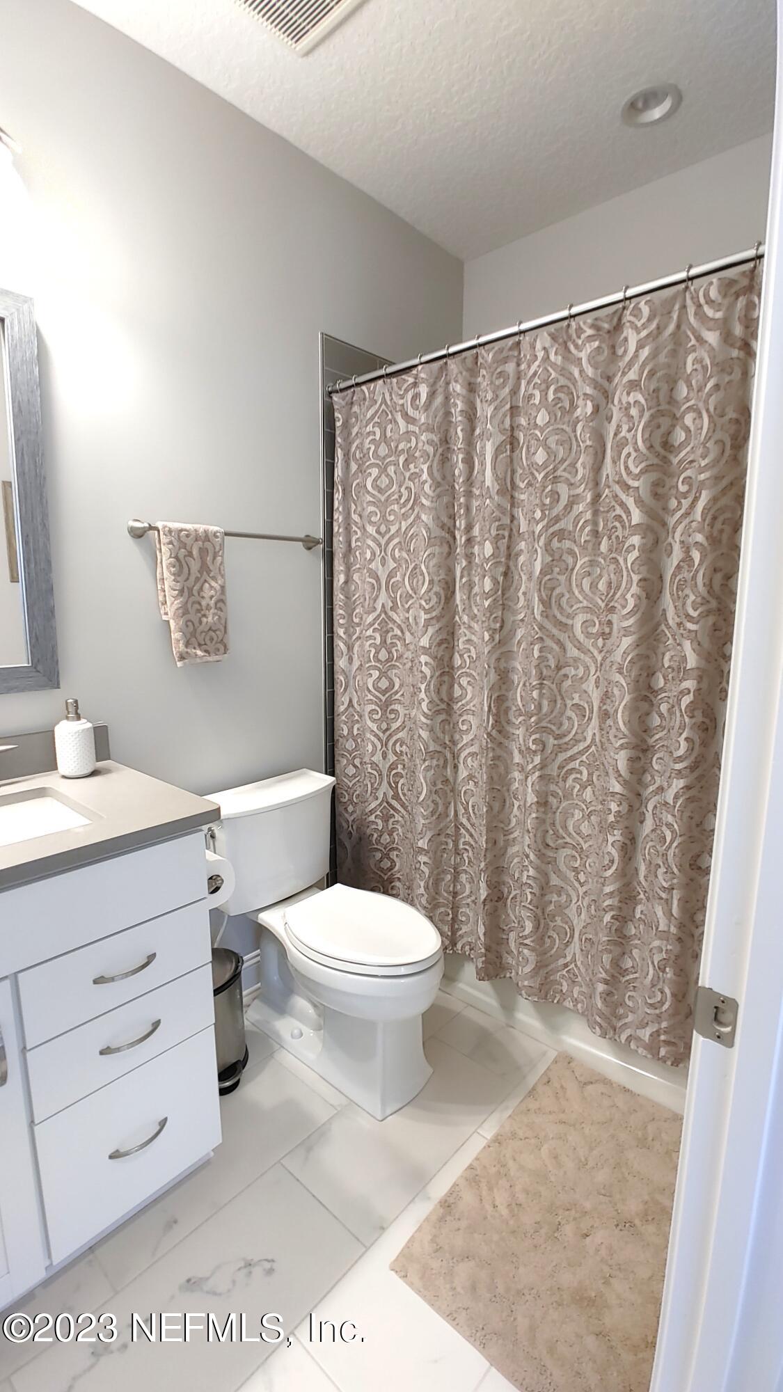 133 Pavati Point St. Johns, FL 32259 - Photo 39 of 46 a bathroom with a toilet a sink and a shower