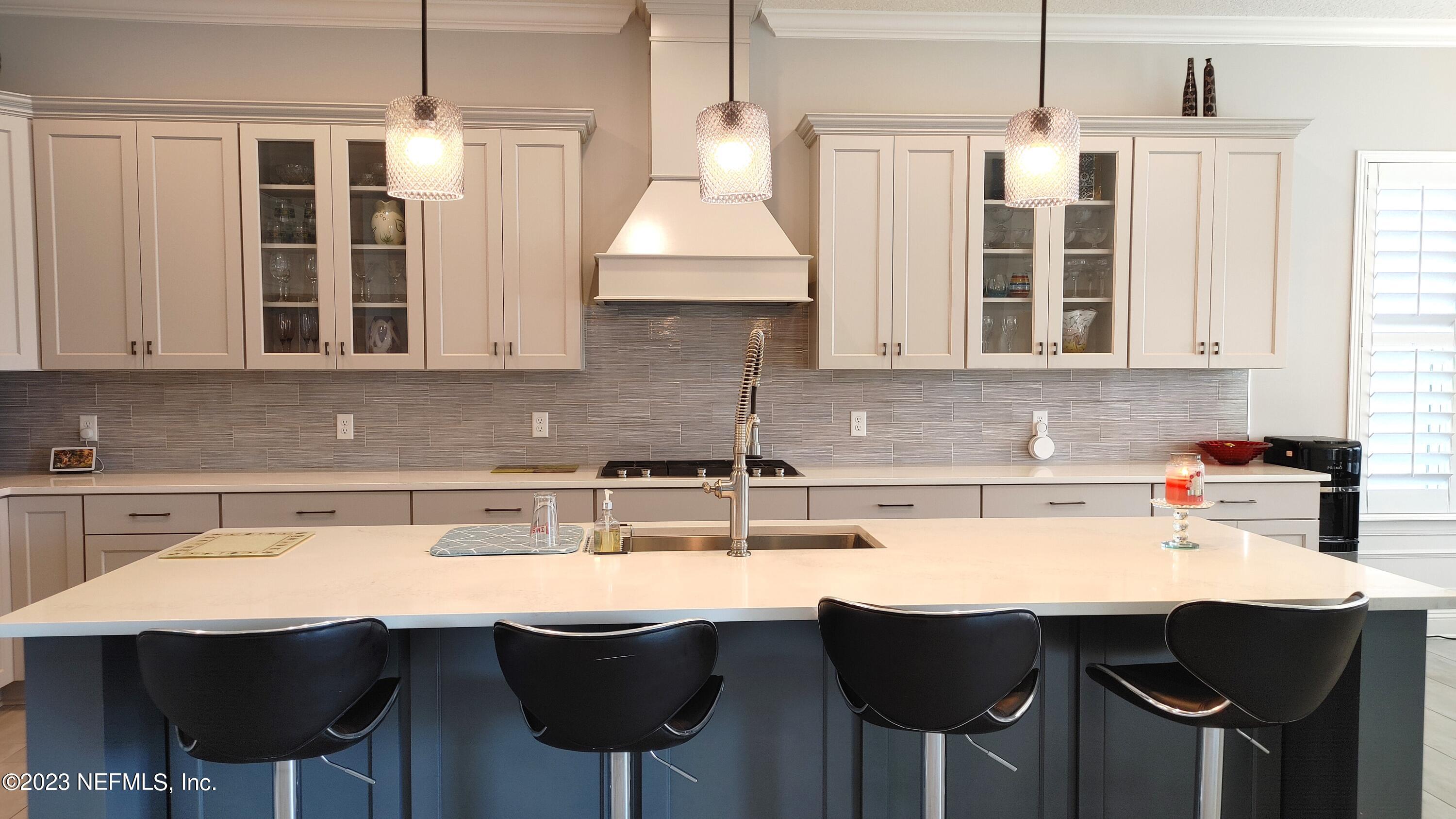 133 Pavati Point St. Johns, FL 32259 - Photo 10 of 46 a kitchen with a sink and chairs
