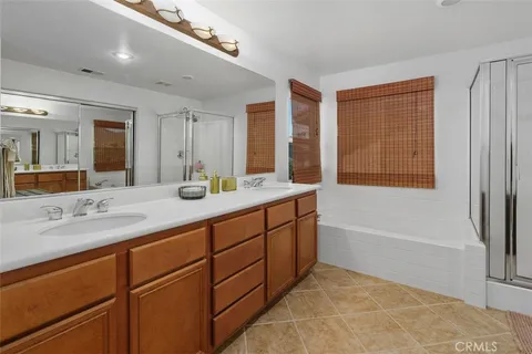 a bathroom with a tub shower and sink