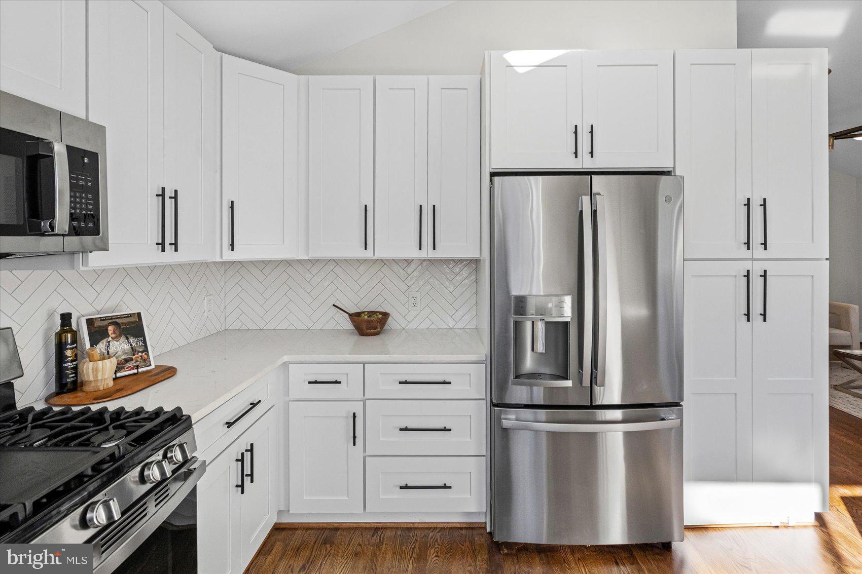 605 Elfin Avenue Capitol Heights, MD 20743 - Photo 12 of 42 a kitchen with stainless steel appliances a refrigerator stove and white cabinets
