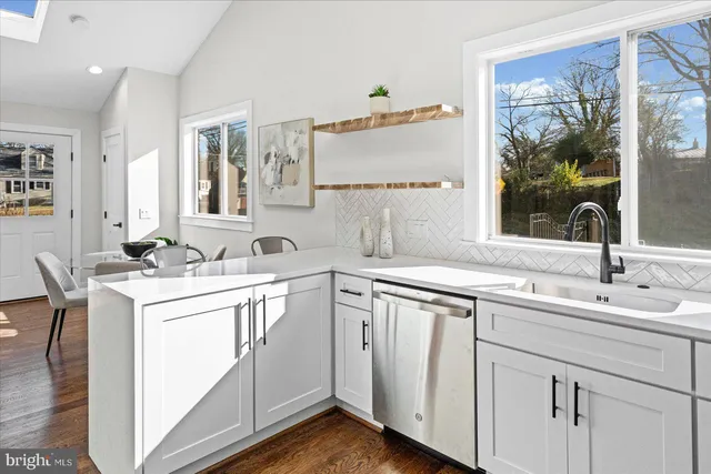 a view with double vanity sink a mirror and a window