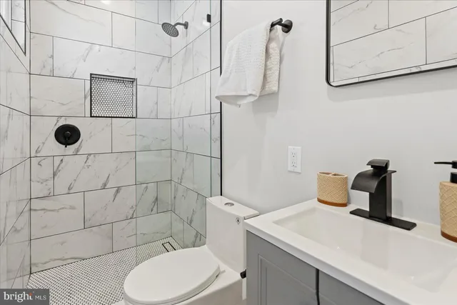 a bathroom with a sink toilet and shower