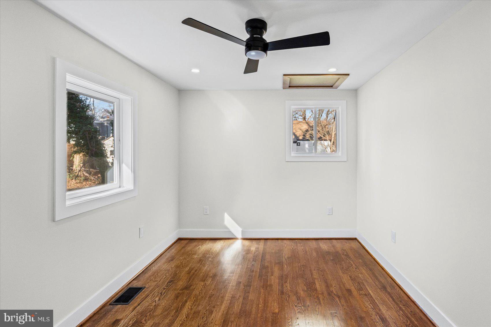605 Elfin Avenue Capitol Heights, MD 20743 - Photo 24 of 42 an empty room with wooden floor and windows