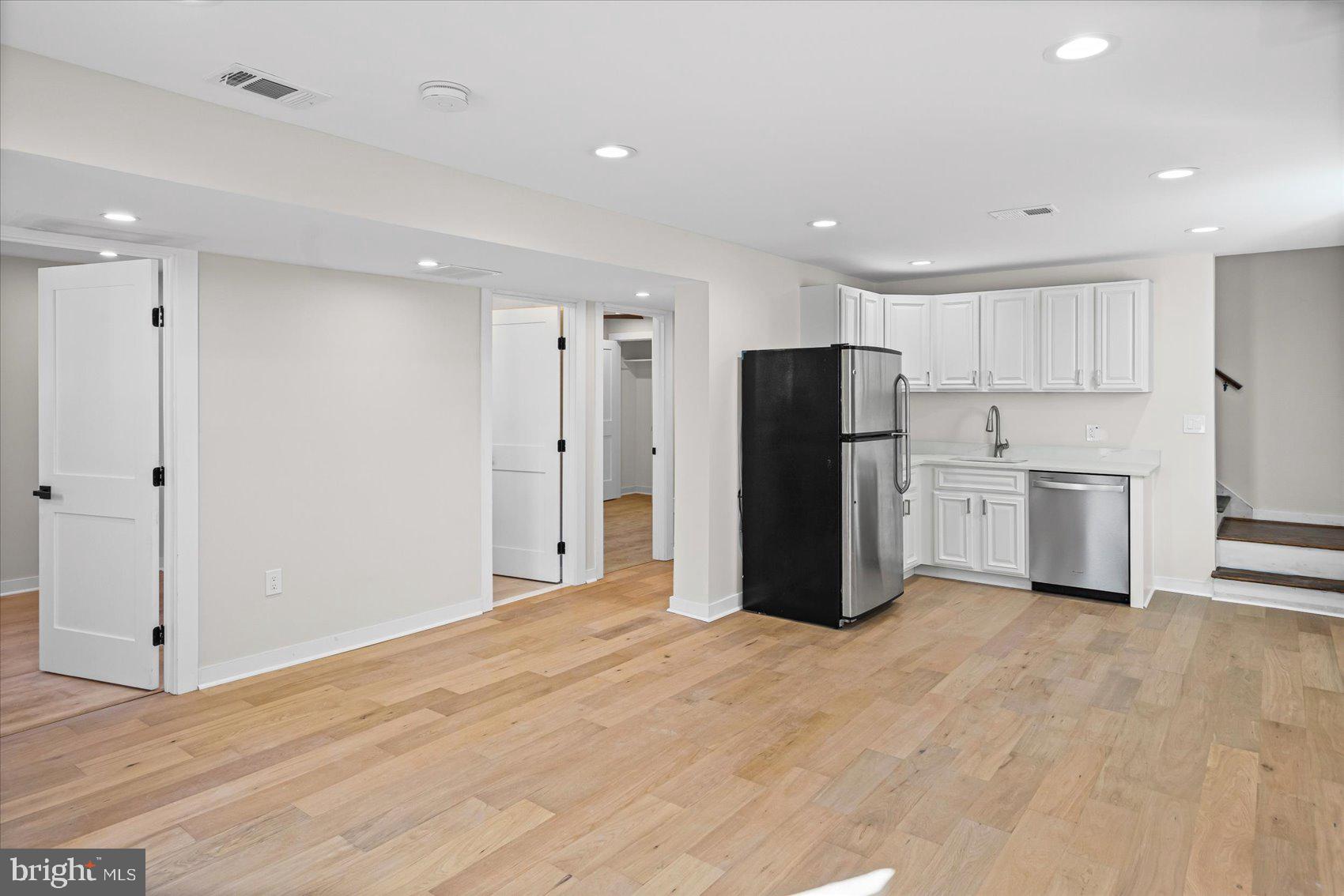 605 Elfin Avenue Capitol Heights, MD 20743 - Photo 25 of 42 a view of a kitchen with refrigerator and white cabinets