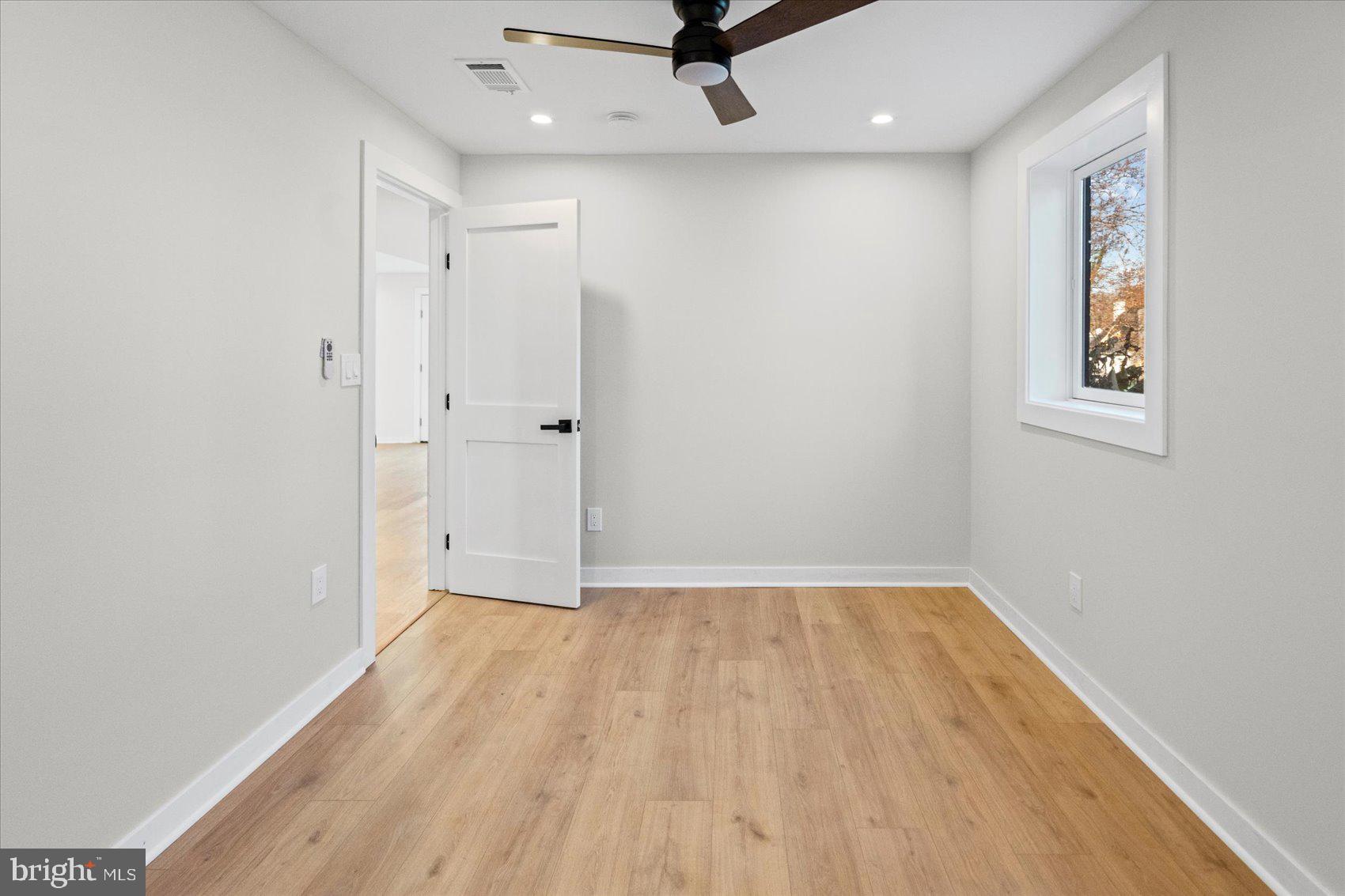 605 Elfin Avenue Capitol Heights, MD 20743 - Photo 29 of 42 wooden floor in an empty room with a window