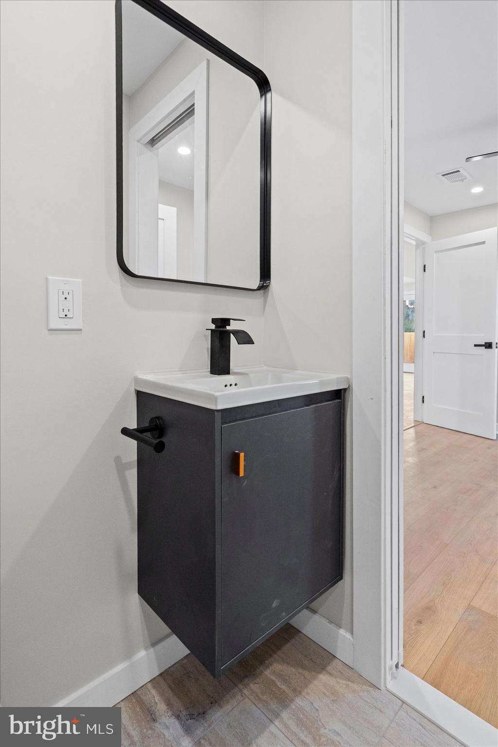 605 Elfin Avenue Capitol Heights, MD 20743 - Photo 32 of 42 a bathroom with a sink and a mirror