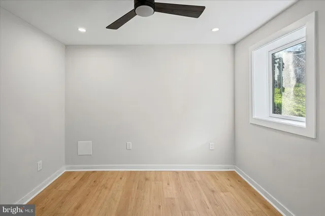 wooden floor in an empty room with a window