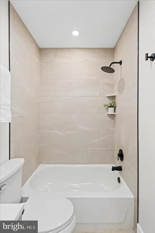 a bathroom with a bathtub and a toilet