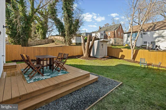 a view of a house with backyard sitting area and garden