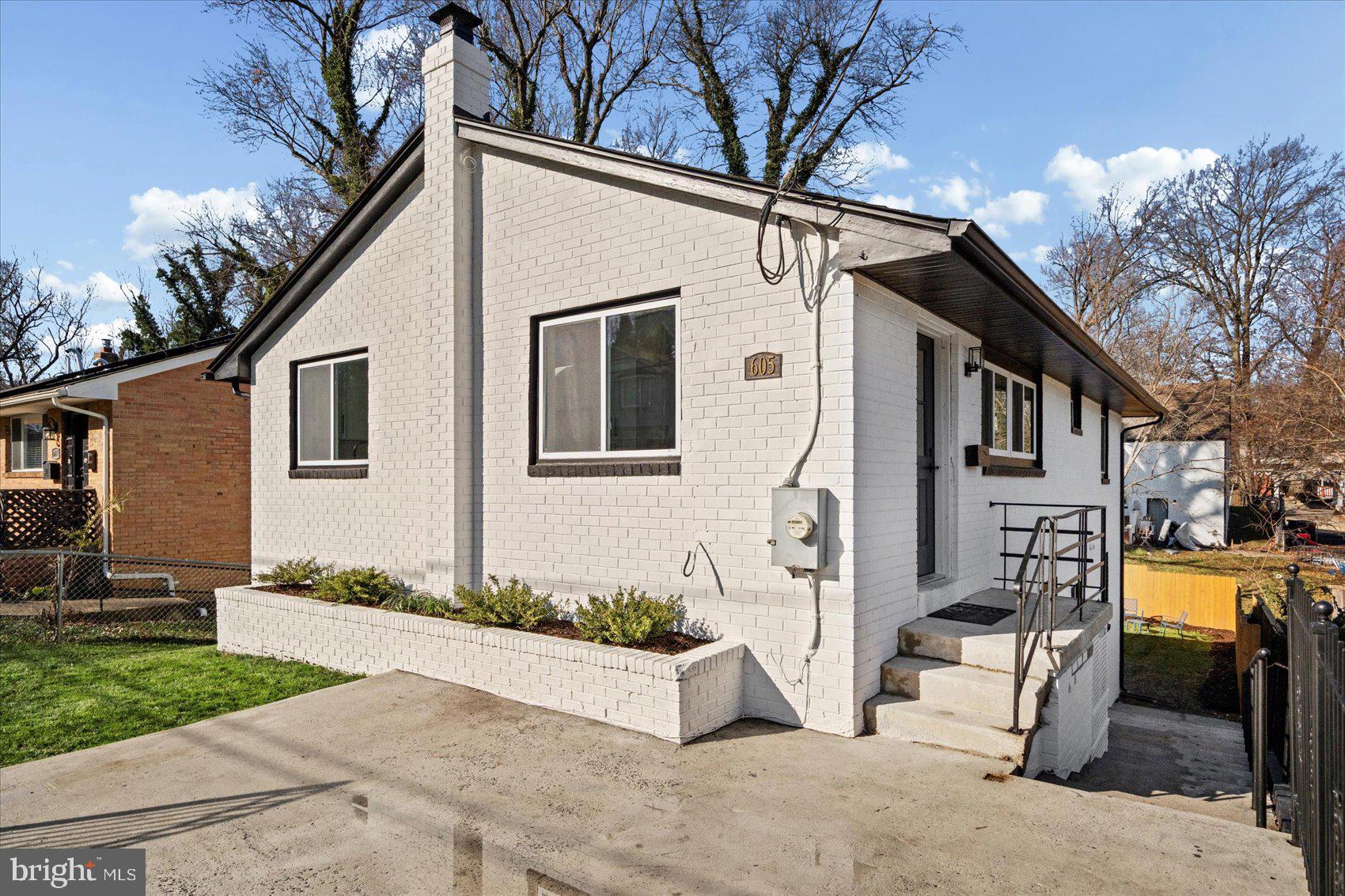 605 Elfin Avenue Capitol Heights, MD 20743 - Photo 5 of 42 a view of a white house with a large tree and a yard