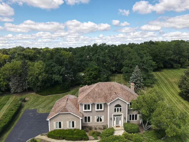 a aerial view of a house next to a yard