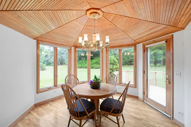 a dining room with furniture wooden floor and a potted plant