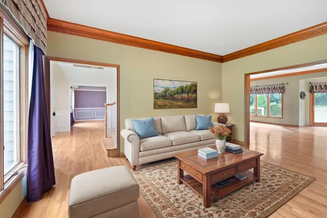 a living room with furniture a rug and a window
