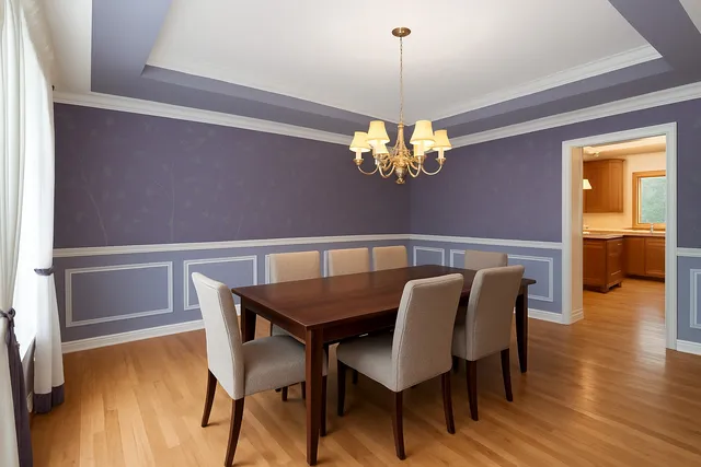 a view of a dining room with furniture wooden floor and chandelier