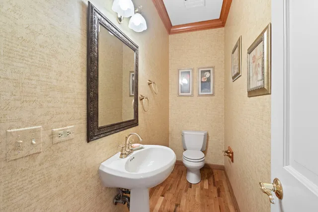 a bathroom with a sink a toilet and mirror