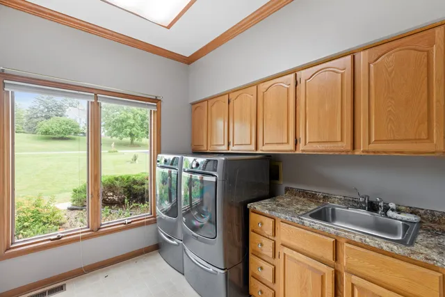 a kitchen with granite countertop a stove a sink and cabinetry