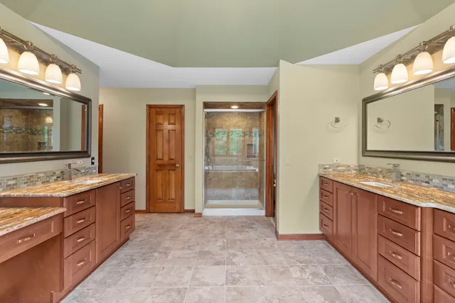 a spacious bathroom with a granite countertop sink mirror and a