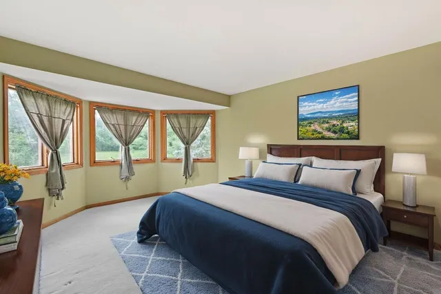 a bedroom with a large bed and a large window