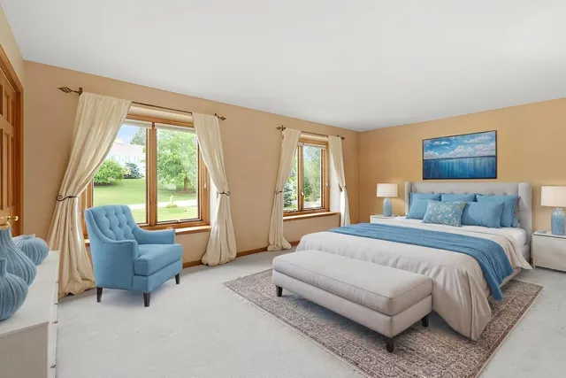 a spacious bedroom with a bed and a large window