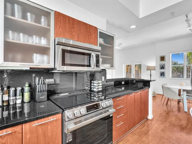 a kitchen with stainless steel appliances granite countertop a stove and cabinets